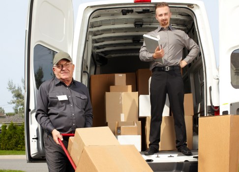 Professional piano removals team preparing an upright piano for safe transport in Streatham